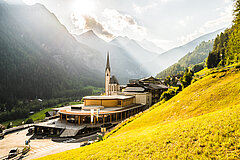 Bild vom Haus der Steinböcke mit der Kirche von Heiligenblut und Link zu Anreise und Parken